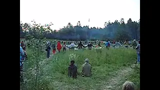 Saying OM mantra in the circle in Rainbow Gathering in Karelia, Russia